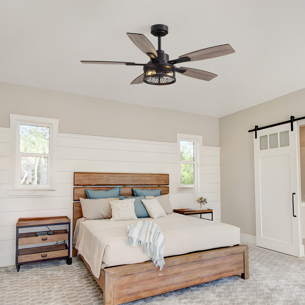 51" farmhouse ceiling fan in bedroom — wood plank headboard, shiplap walls, barn door, blue accent pillows, rustic wooden bed frame | CARRA HOME