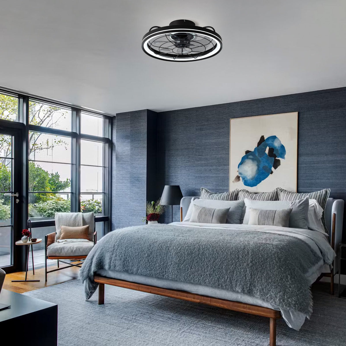 Aerox Caged Ceiling Fan in modern bedroom — gray bedding, blue abstract art, large windows, quiet reversible airflow, smart control for restful sleep | CARRA HOME
