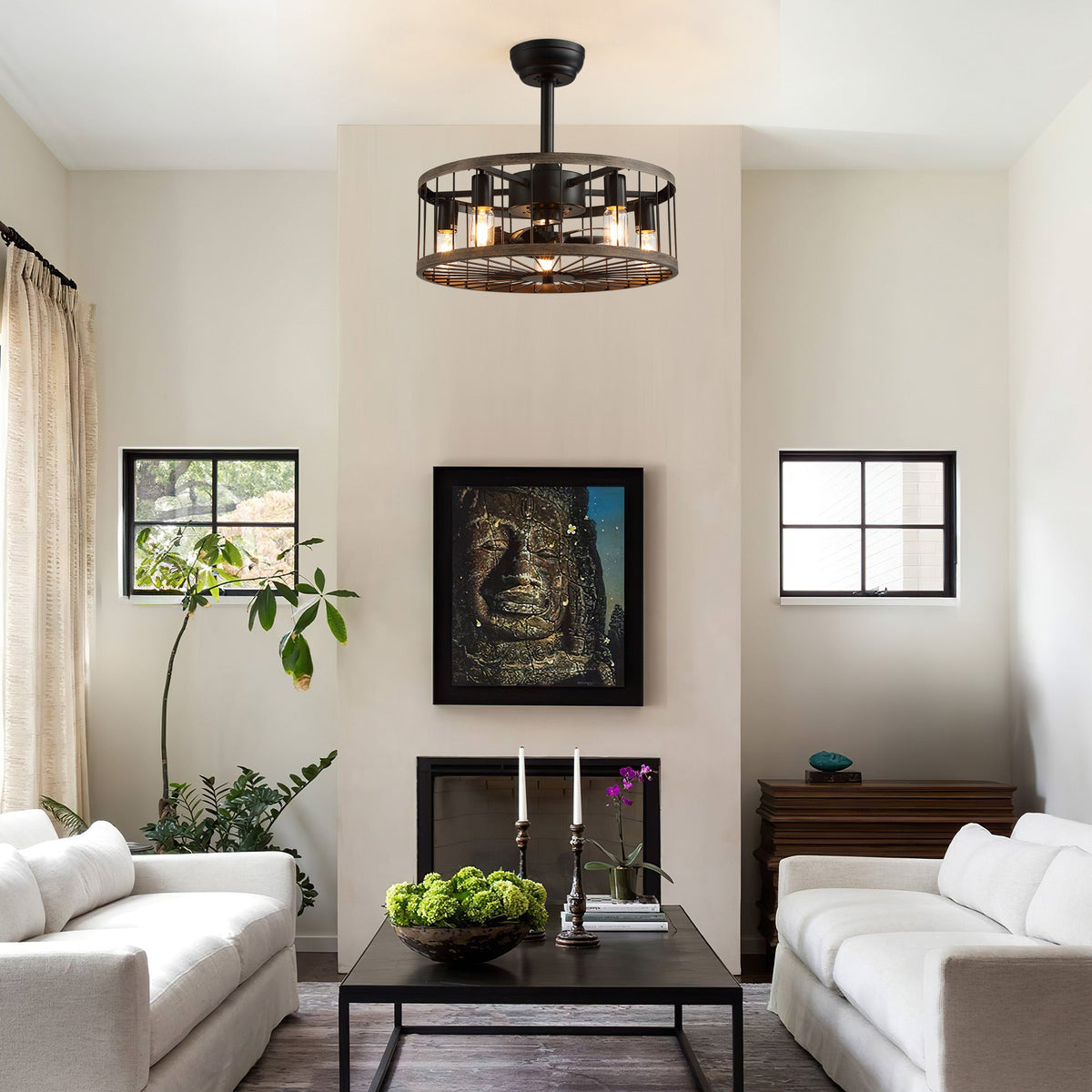 Aerozen caged ceiling fan in modern living room — black metal drum cage, Edison bulbs, brick fireplace, abstract art, cozy farmhouse industrial ambiance | CARRA HOME