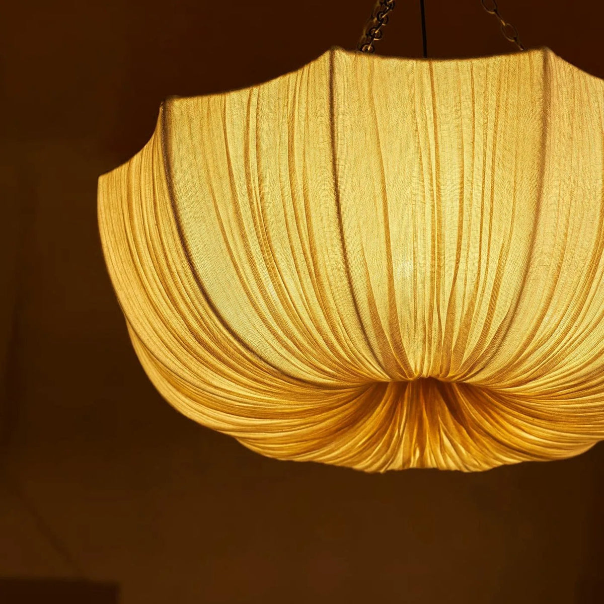 Aldwin pleated cotton shade detail with the light switched on | CARRA HOME