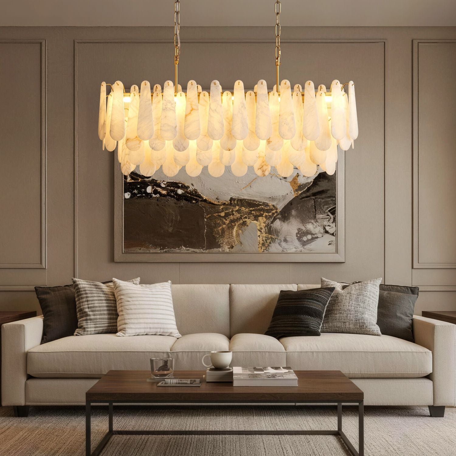 Apex Modern Minimalist Alabaster Linear Chandelier centered above a beige upholstered sofa — set against a dark gray paneled wall with a large abstract painting and a wooden coffee table -carra-home