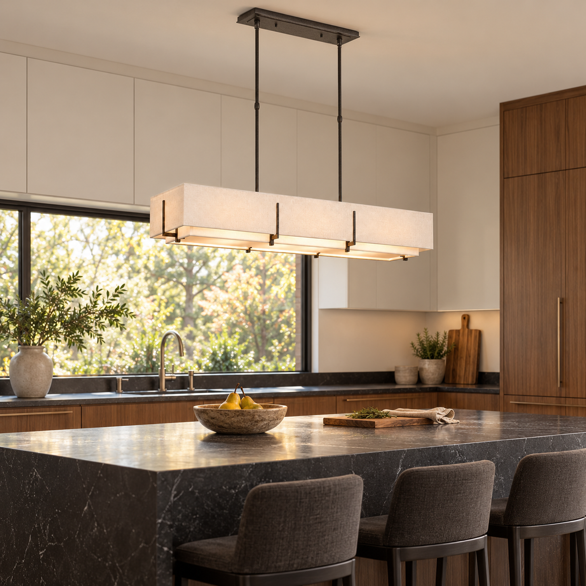 Arden Fabric Double-Shade Linear Chandelier above a walnut kitchen island | CARRA HOME