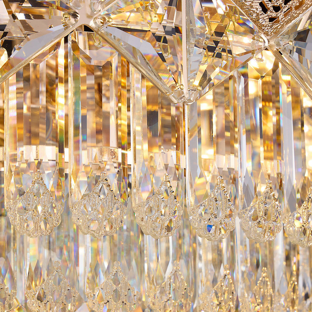 Close-up of Aureme Chandelier’s gold-tone metal base — textured grip band, polished finish, and secure chain attachment point | Carra Home