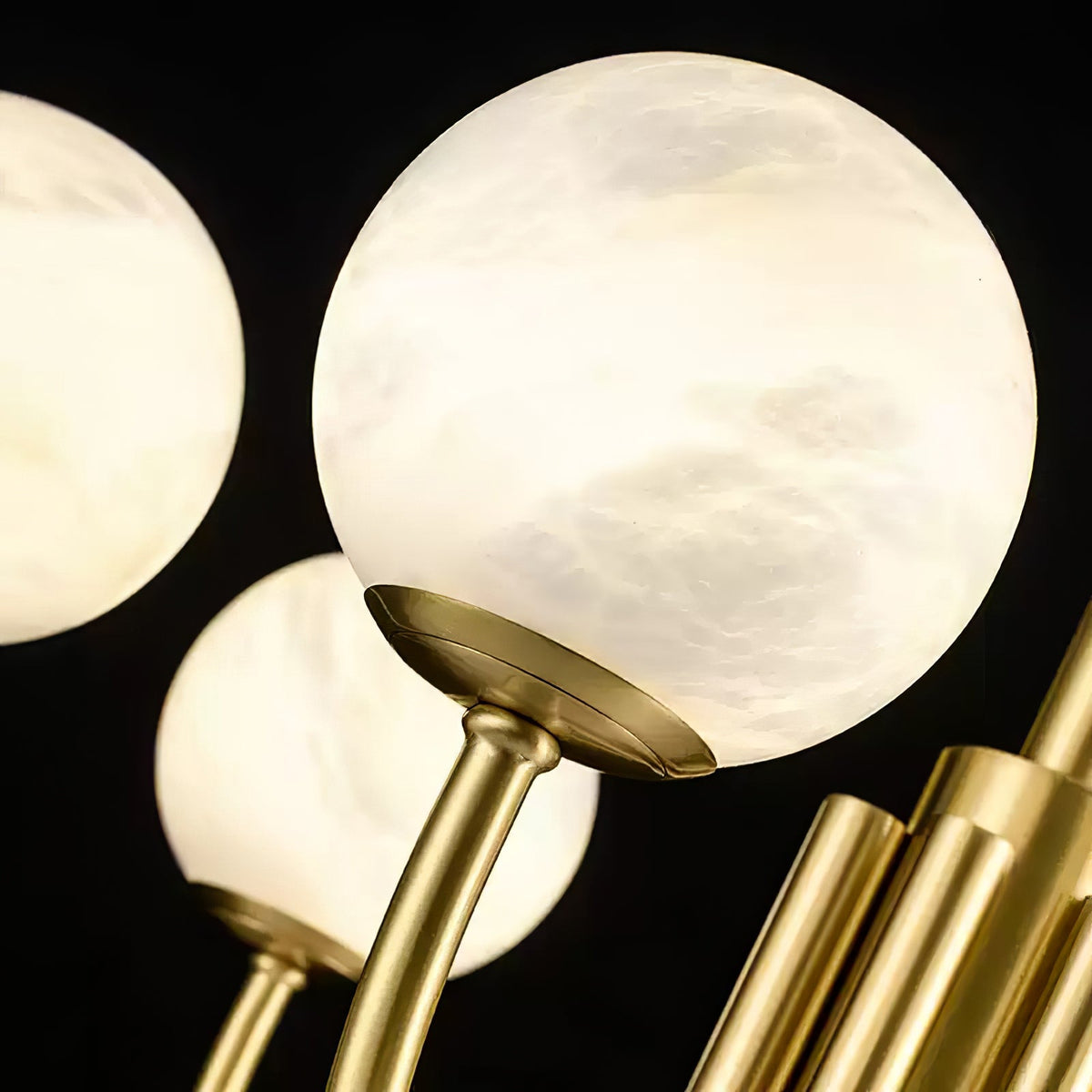 Illuminated alabaster globe and gold socket detail | CARRA HOME