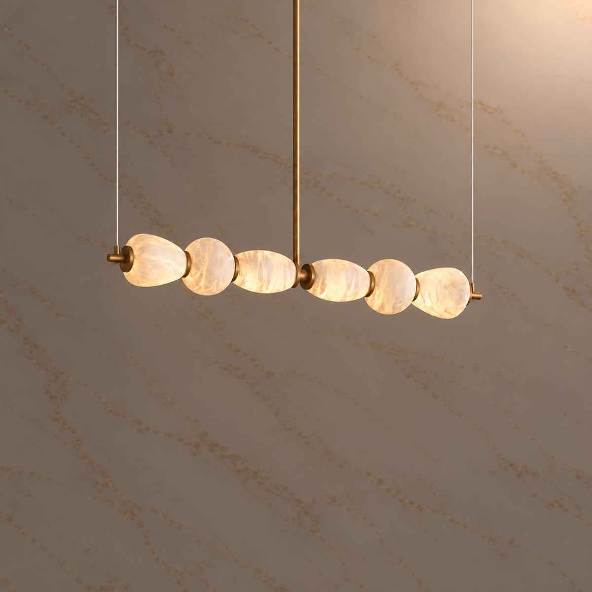 Cairn Alabaster Pebble Linear Chandelier gold 135cm, light on | CARRA HOME