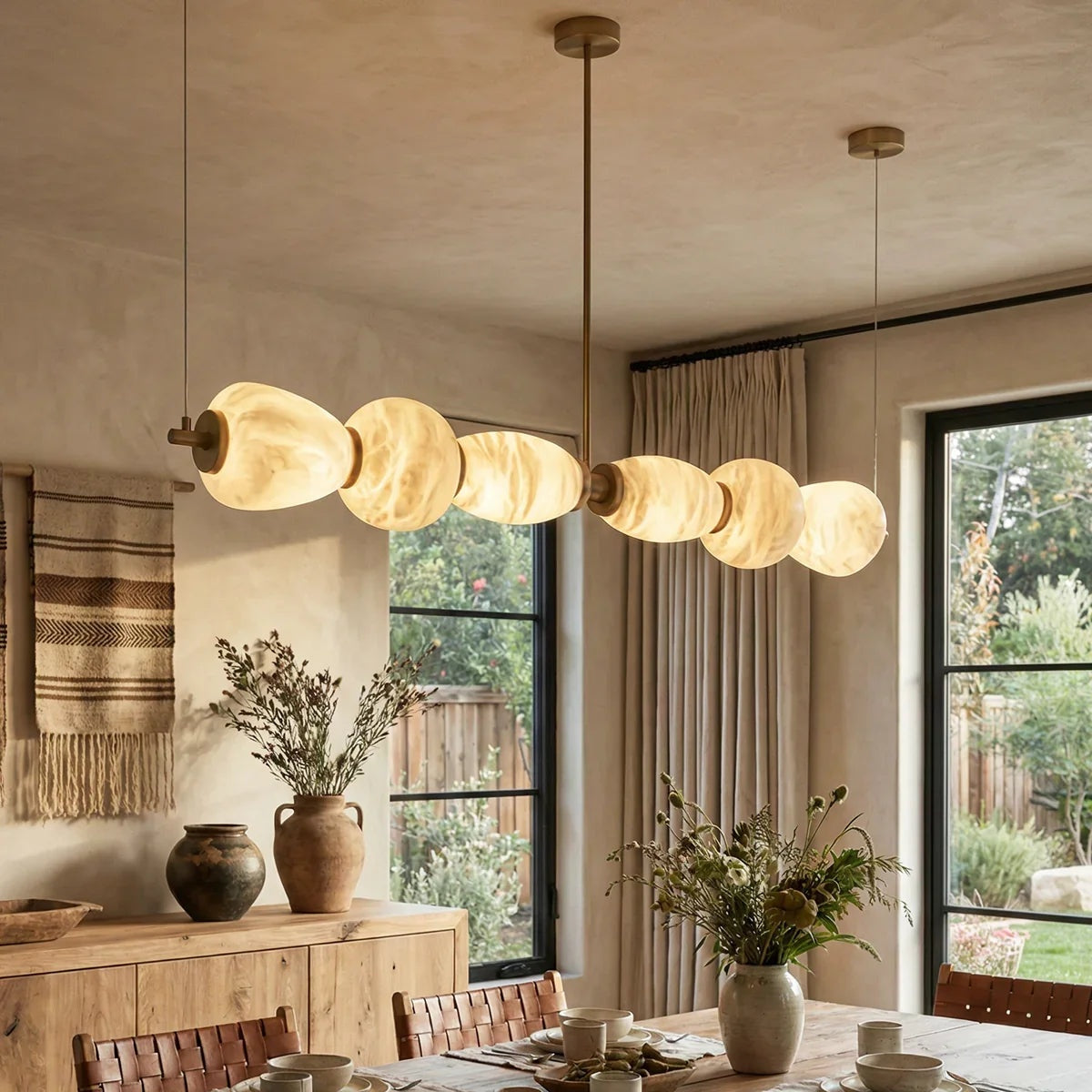 Alabaster pebble chandelier in a natural dining room | CARRA HOME