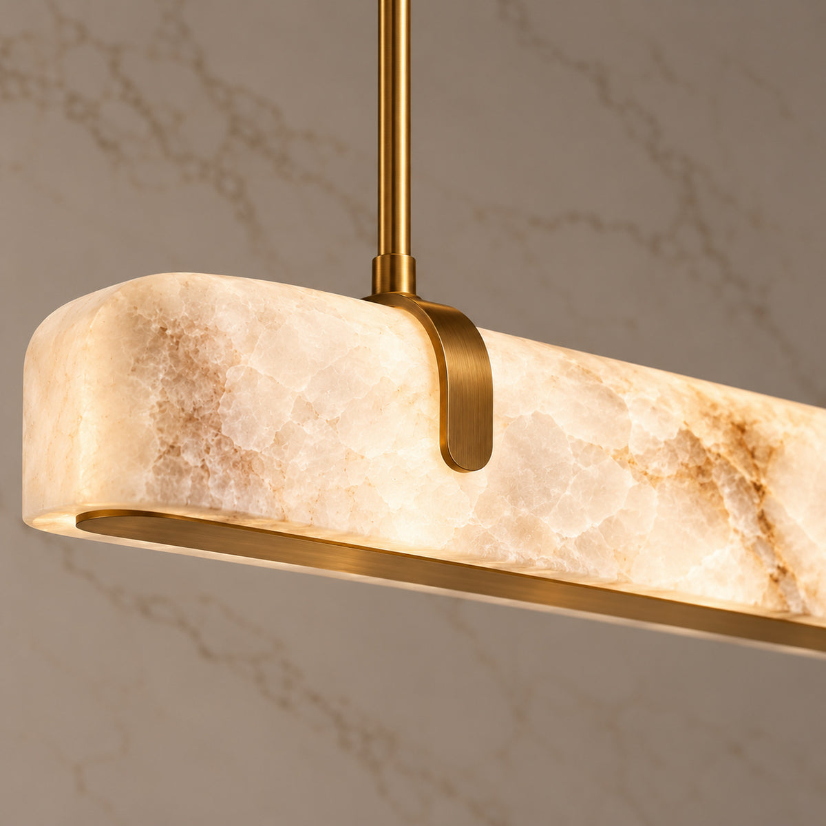 Calen Alabaster Linear Chandelier — Natural alabaster veining and curved brass saddle detail | CARRA HOME