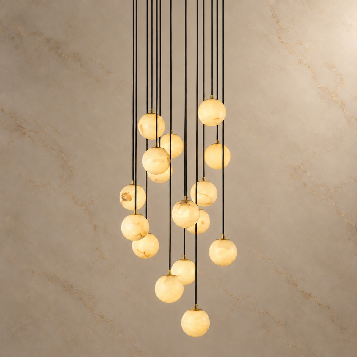 Celestelle Alabaster Globe Cluster Chandelier, 16 natural alabaster globes with black suspension cords and gold details, light on | CARRA HOME