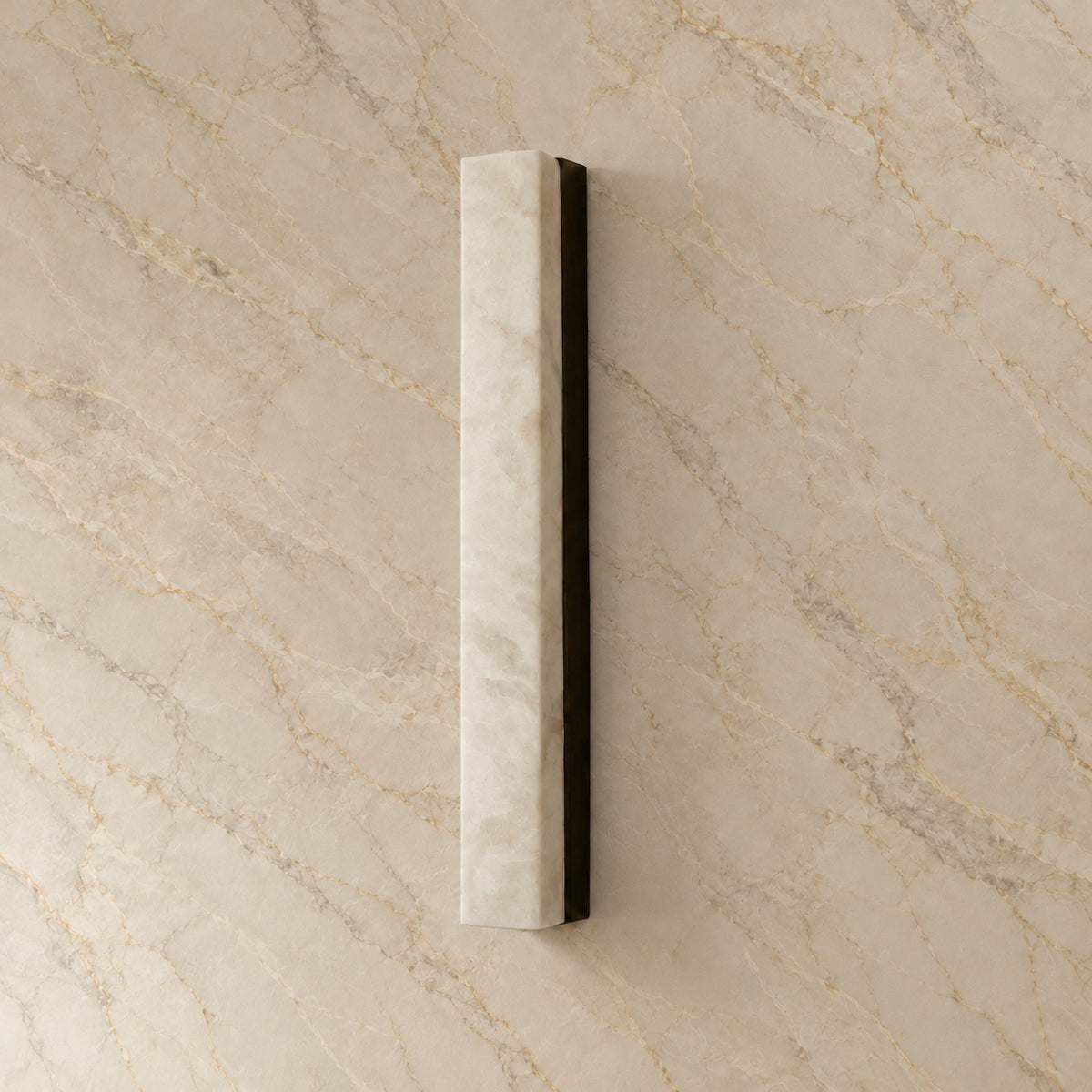 Dara Alabaster Linear Wall Sconce with black hardware, switched off, on a marble wall | CARRA HOME