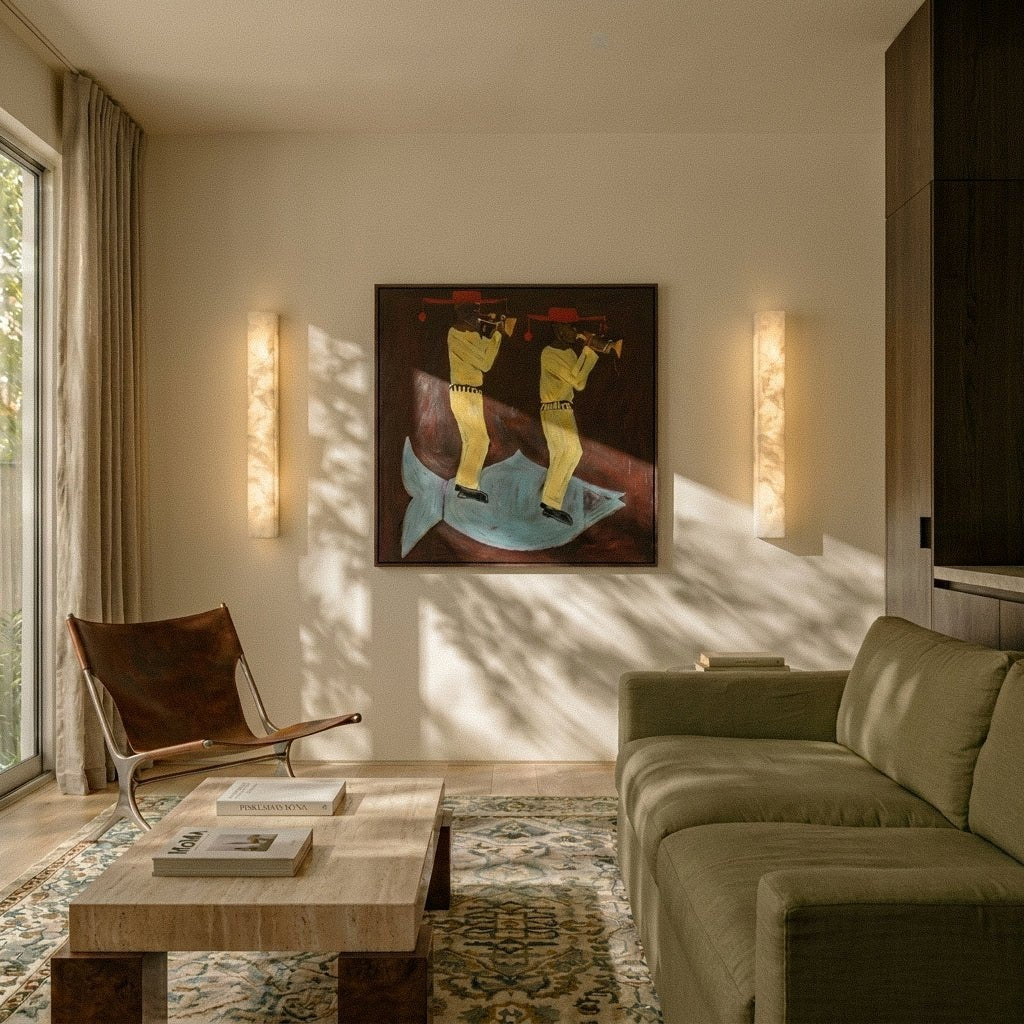 Dara alabaster wall sconces flanking artwork in a living room | CARRA HOME
