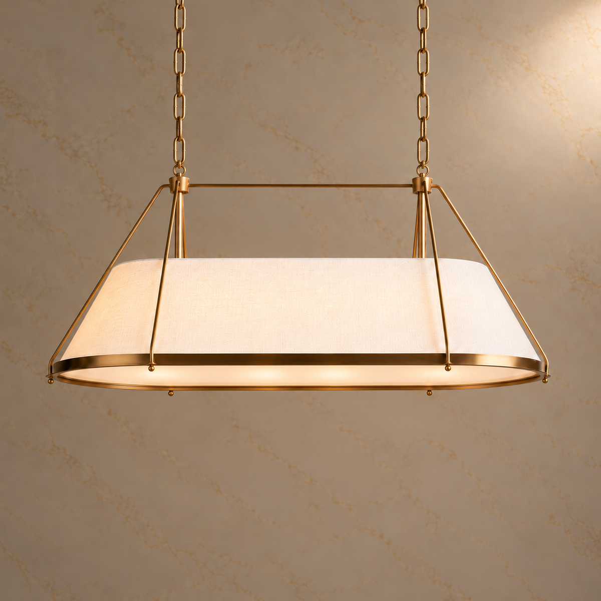 Ellery Linen Tapered Linear Chandelier with warm illumination and burnished brass framing on a subtle marble backdrop | CARRA HOME