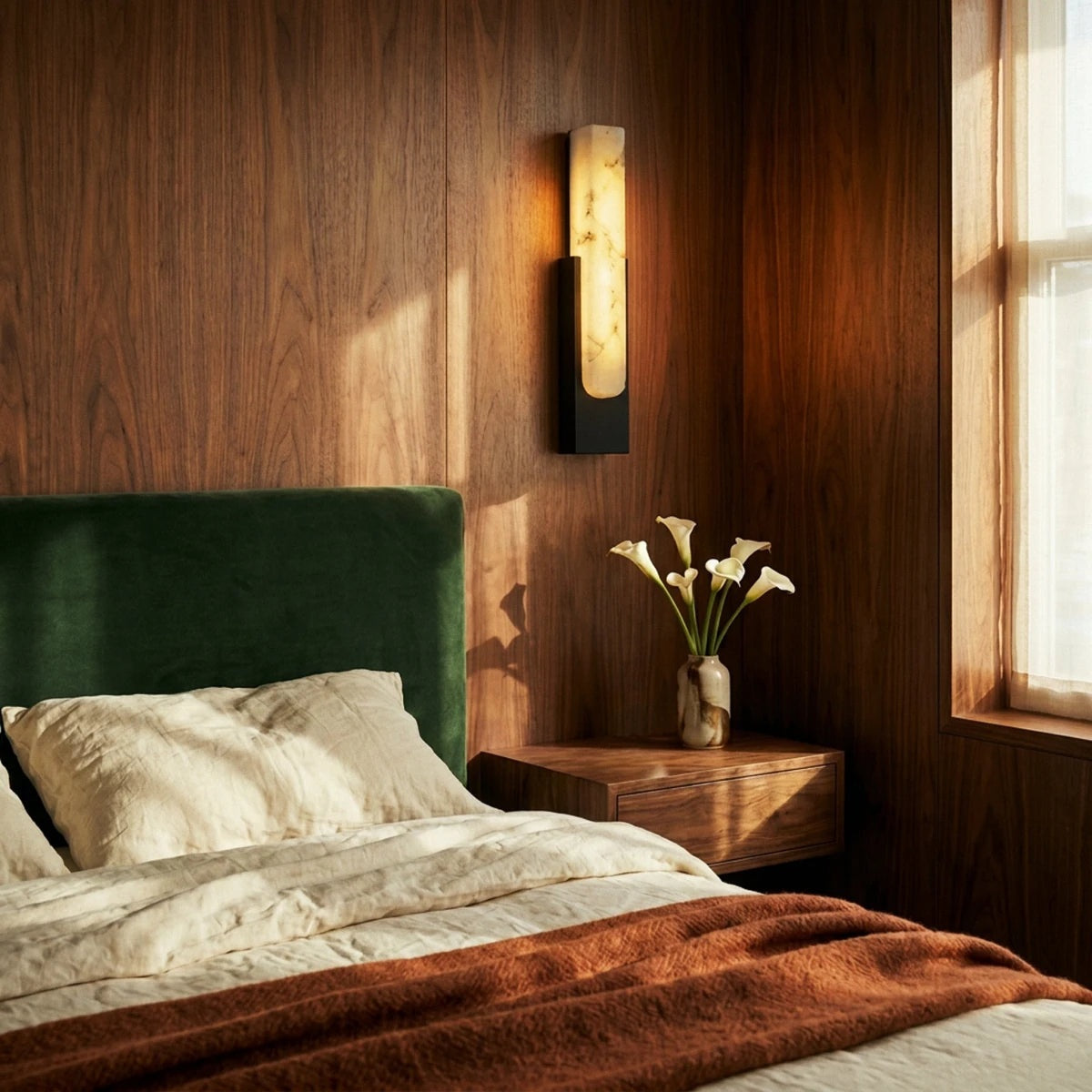 Emilia black wall sconce beside a bed | CARRA HOME