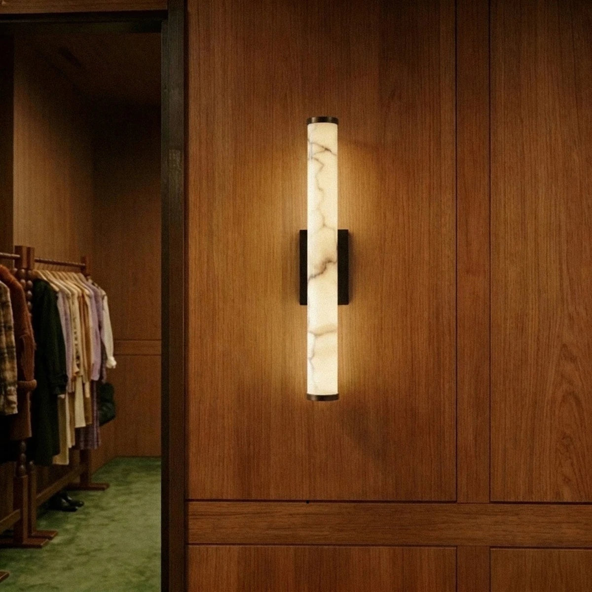 Falynis wall sconce on a wood-panelled interior wall | CARRA HOME