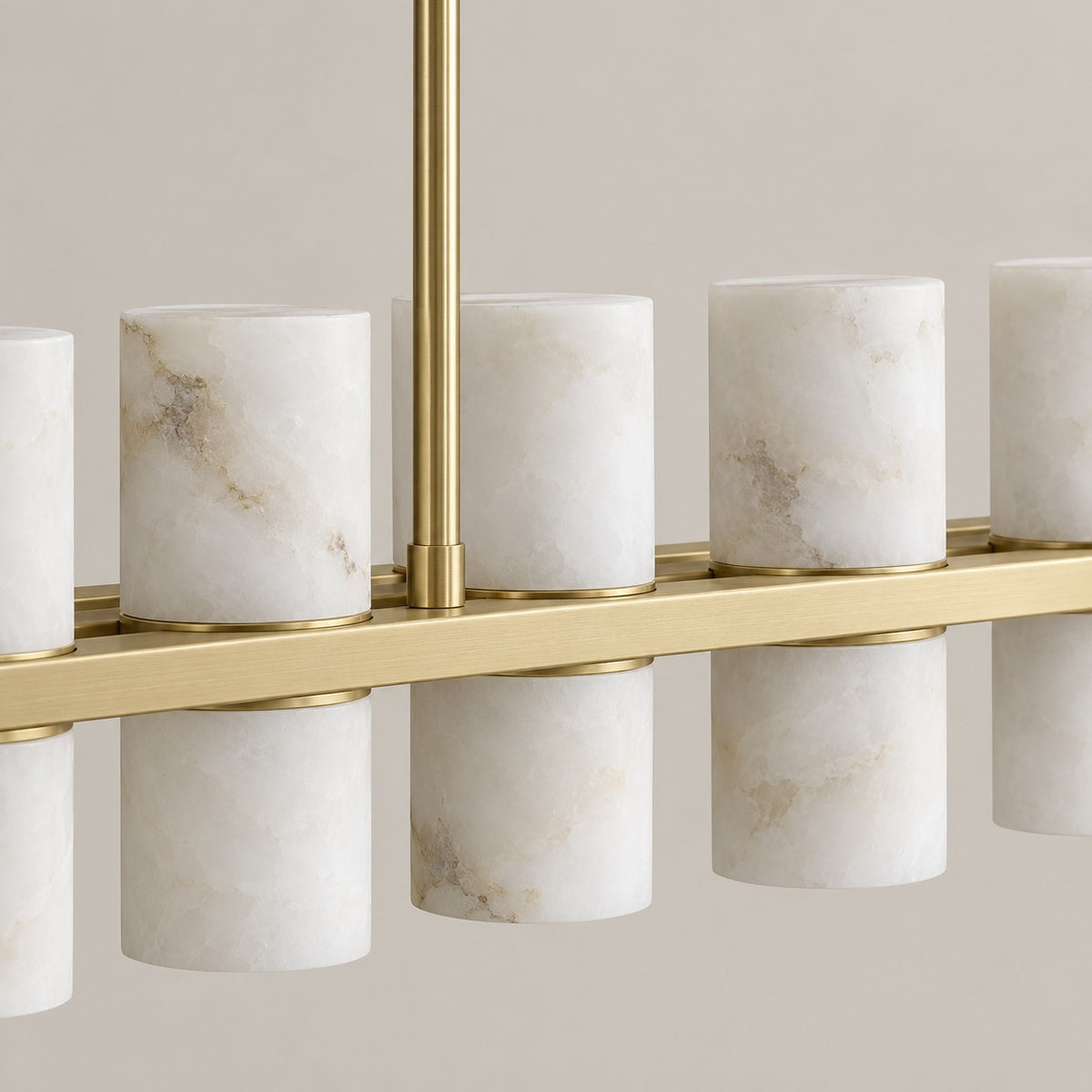 Natural alabaster cylinders and gold linear frame detail | CARRA HOME