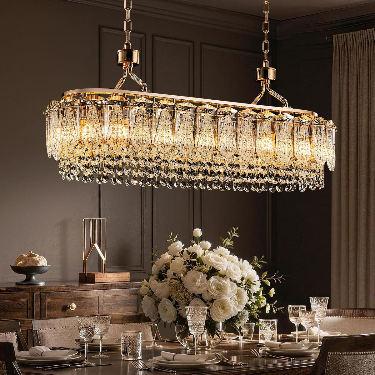 Glacier Modern Linear Ice-Cracked Crystal Chandelier in a luxurious dining room — illuminating a dark wood table set with a grand bouquet of white roses and crystal glassware, against dark paneled walls | CARRA HOME