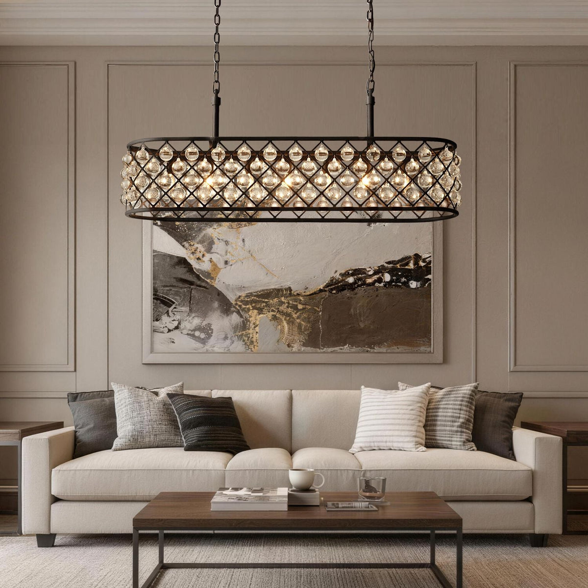 Harlow Modern Industrial Matte Black K9 Crystal Rectangle Chandelier in a living room — suspended above a beige sofa with decorative pillows, a coffee table, and abstract wall art | Carra Home