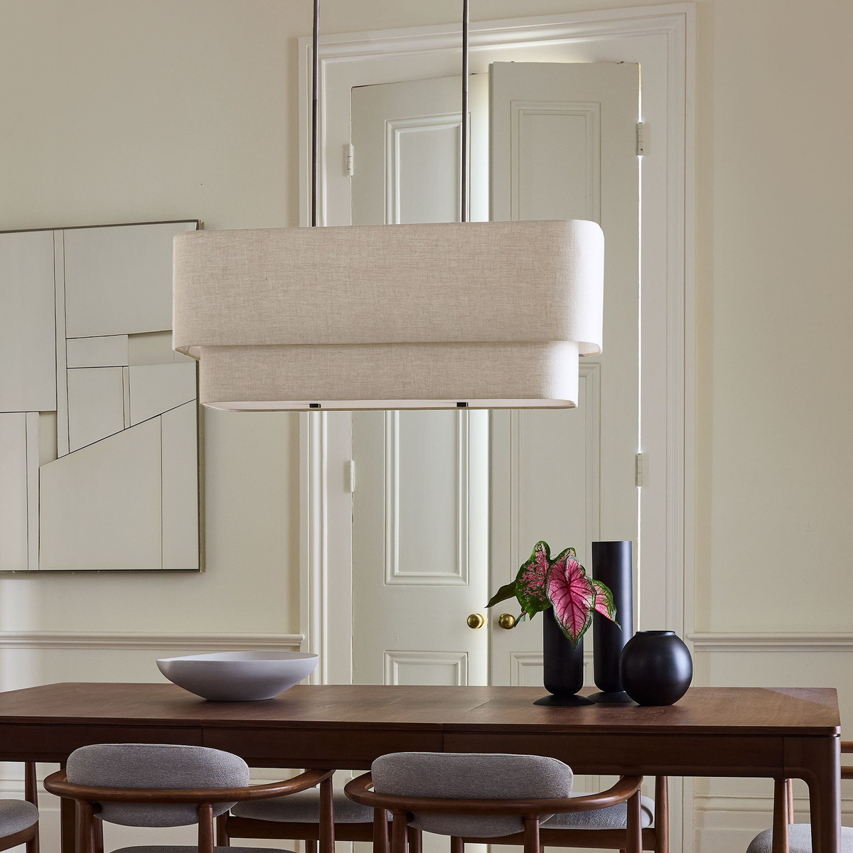 Laren linen chandelier over a walnut dining table in a paneled dining room | CARRA HOME