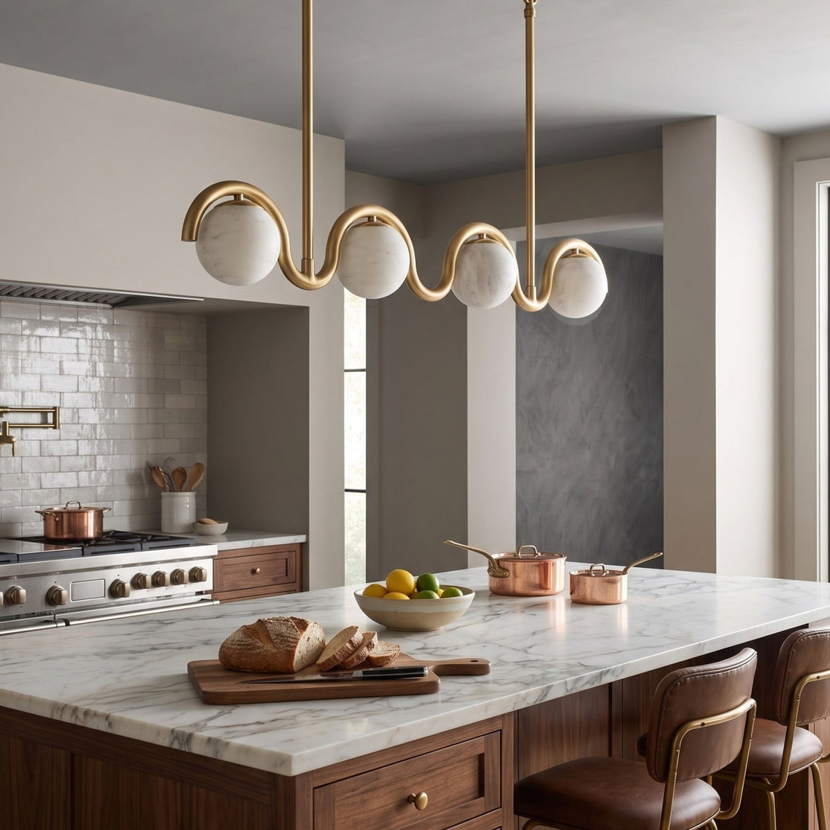 Gold wave chandelier over a wood kitchen island | CARRA HOME