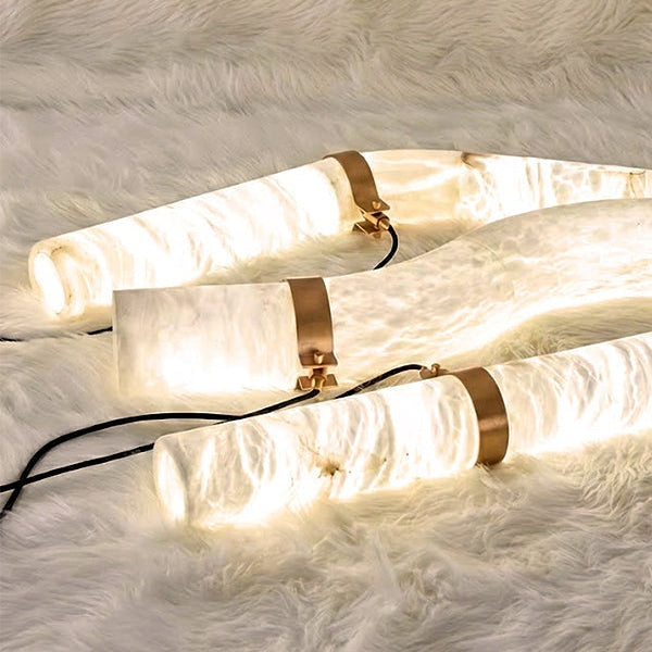 Alabaster tube sections and gold connectors illuminated | CARRA HOME