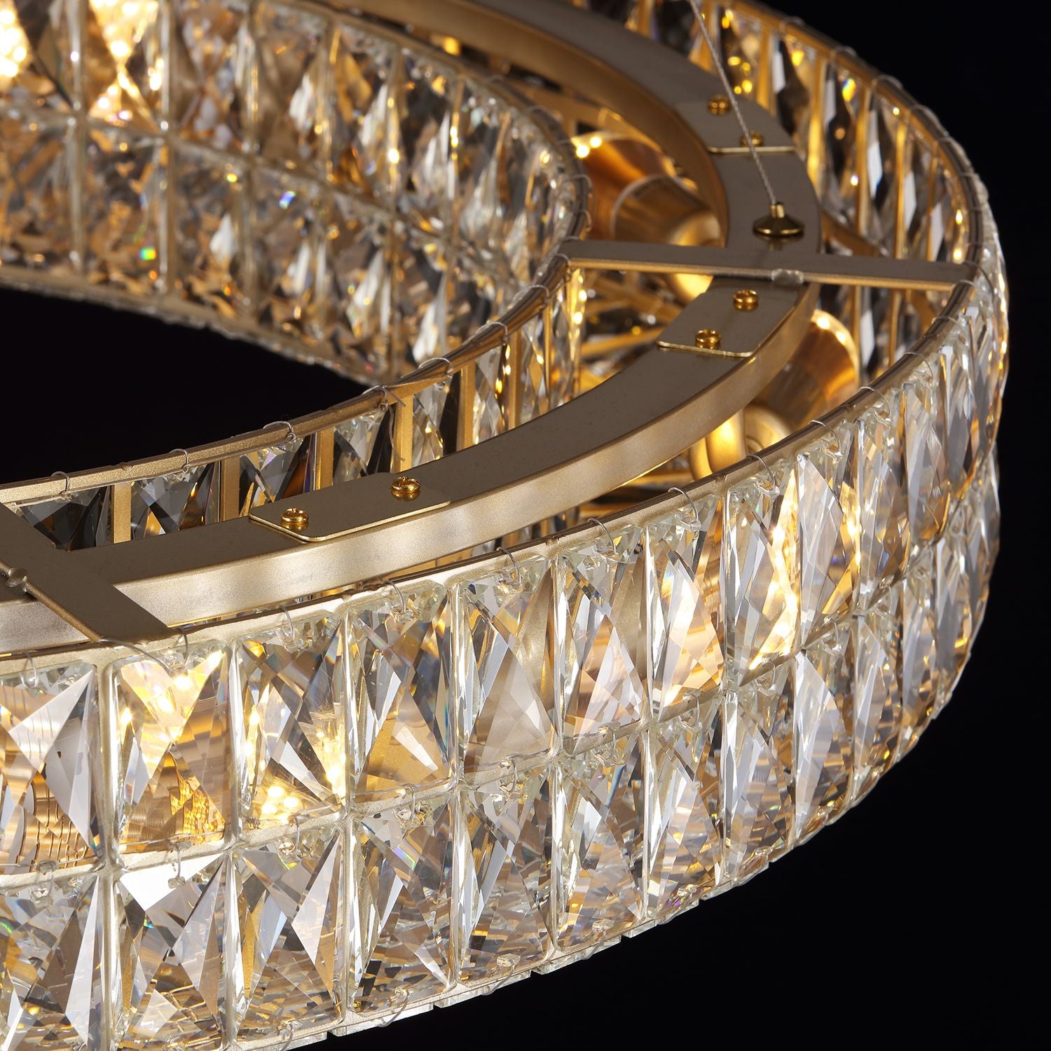 Close-up of Valdore’s crystal prisms — square facets, gold bands, rainbow light refraction | Carra Home