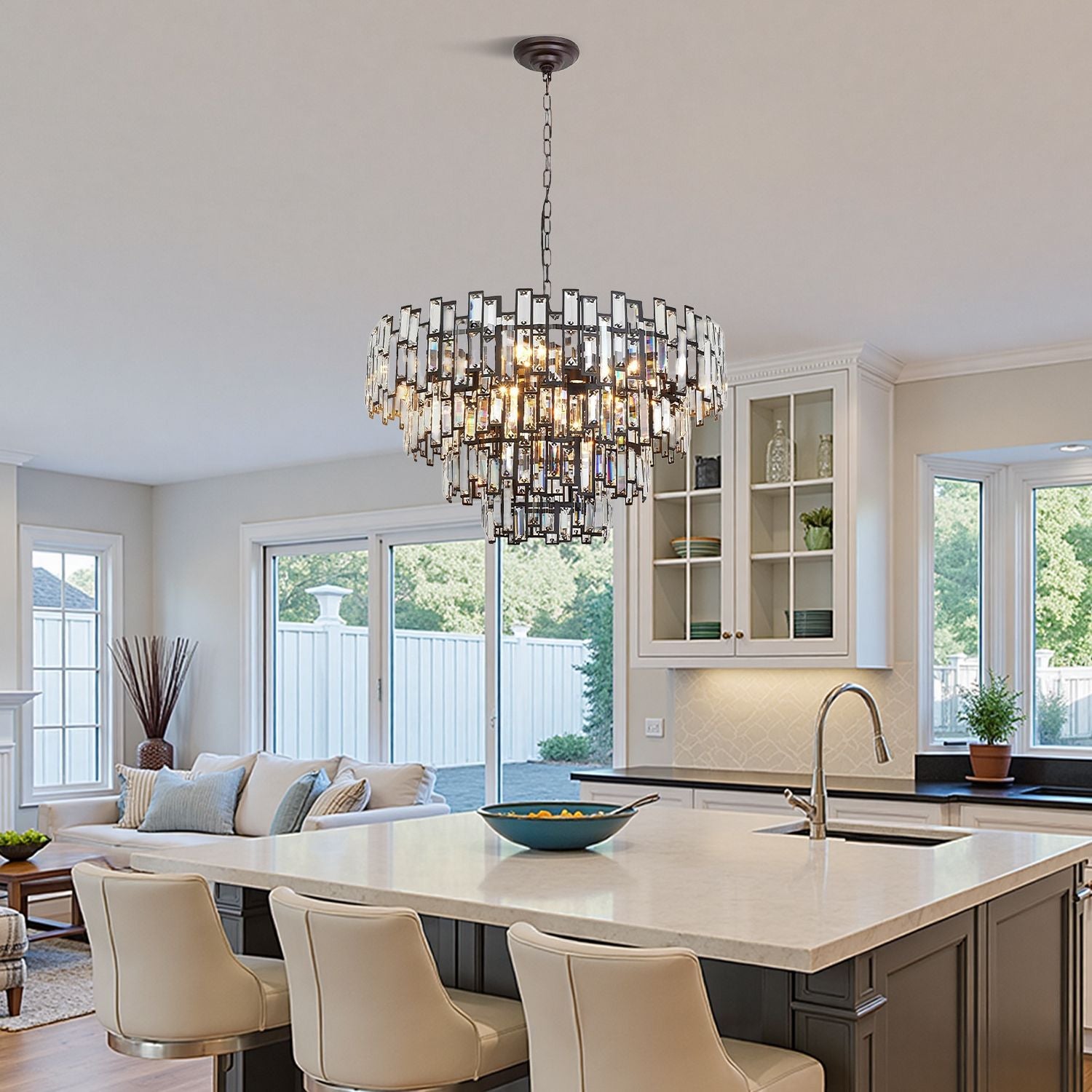 Vera Crystal Prism Tiered Chandelier in a sleek kitchen — illuminating a white quartz island, gray cabinetry, and natural light from large windows | Carra Home