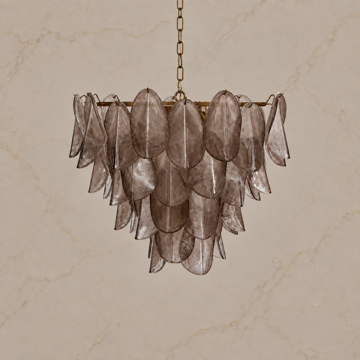 Magnolia taupe glass petal chandelier unlit on warm greige stone | CARRA HOME