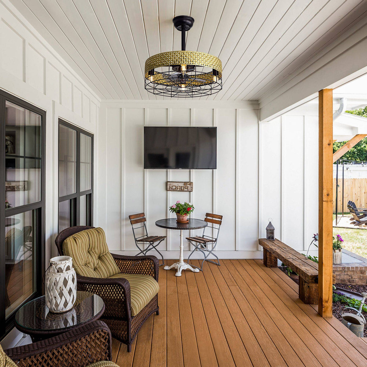 Outdoor patio ceiling fan with rattan cage — covered porch, wood deck, wicker seating, wall TV, outdoor living space | CARRA HOME