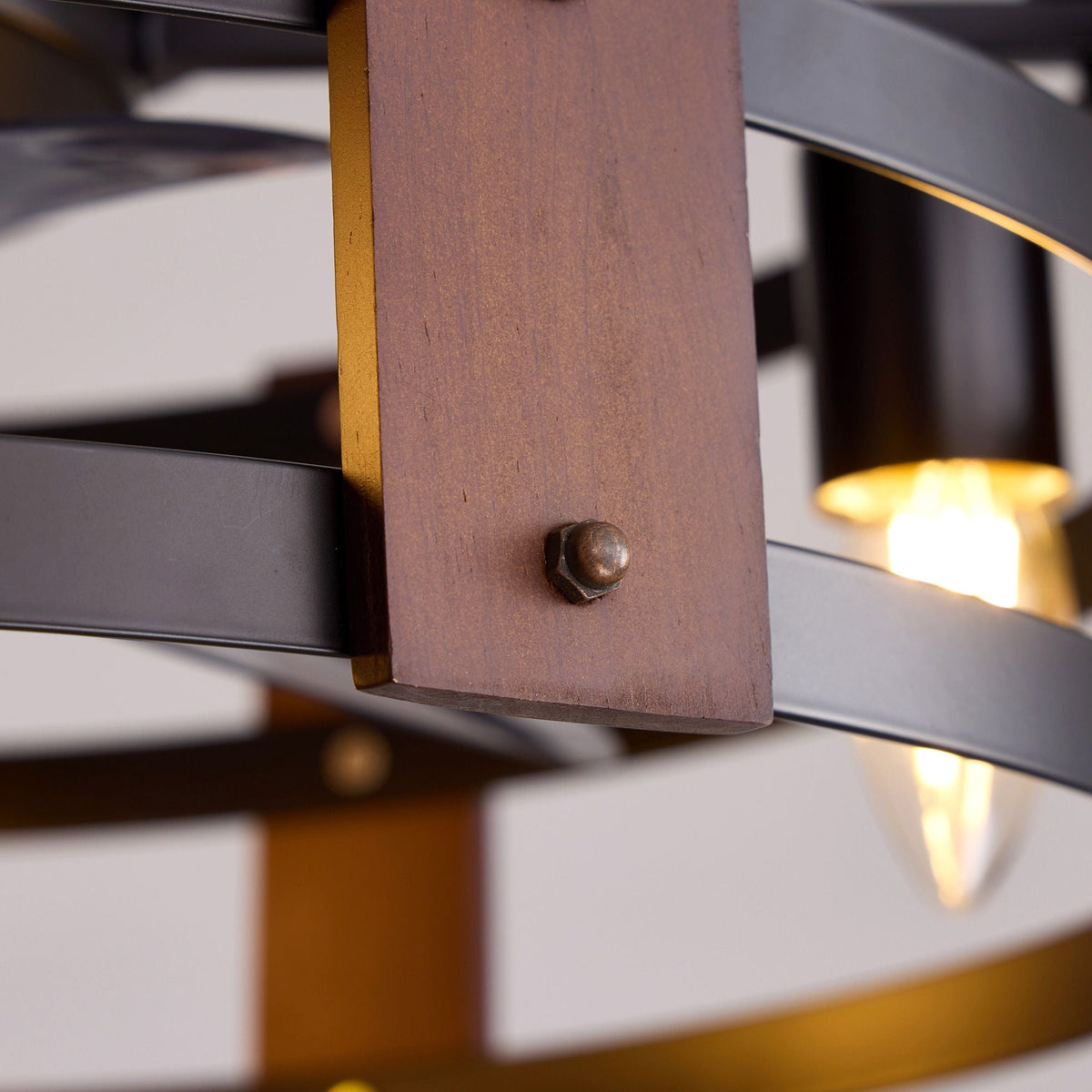 Close-up of rustic wood accent and metal rivet — premium wood grain panel, matte black frame, vintage industrial craftsmanship, warm bulb bokeh | CARRA HOME