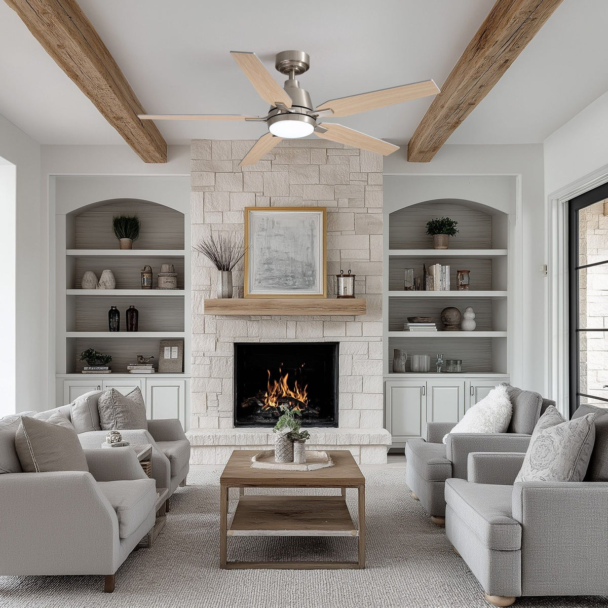 52" ceiling fan in rustic living room — exposed wood beams, stone fireplace, built-in shelves, light gray sofas, warm LED light, spacious farmhouse interior | CARRA HOME