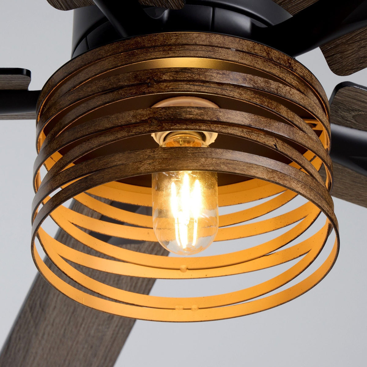 Close-up of amber ribbed glass light shade and black motor housing — vintage Edison bulb glow, gold interior reflector, industrial farmhouse craftsmanship | CARRA HOME