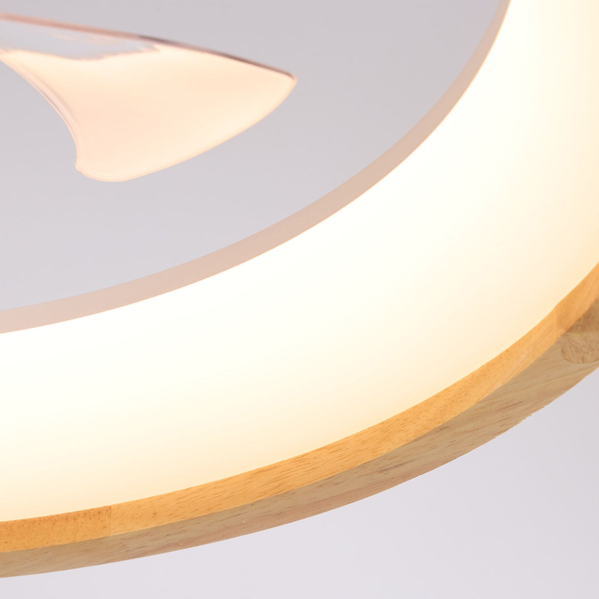 Close-up of Aeria LED Ceiling Fan — warm circular light ring, translucent fan blades, soft glow, wood edge and modern minimal detail | CARRA HOME