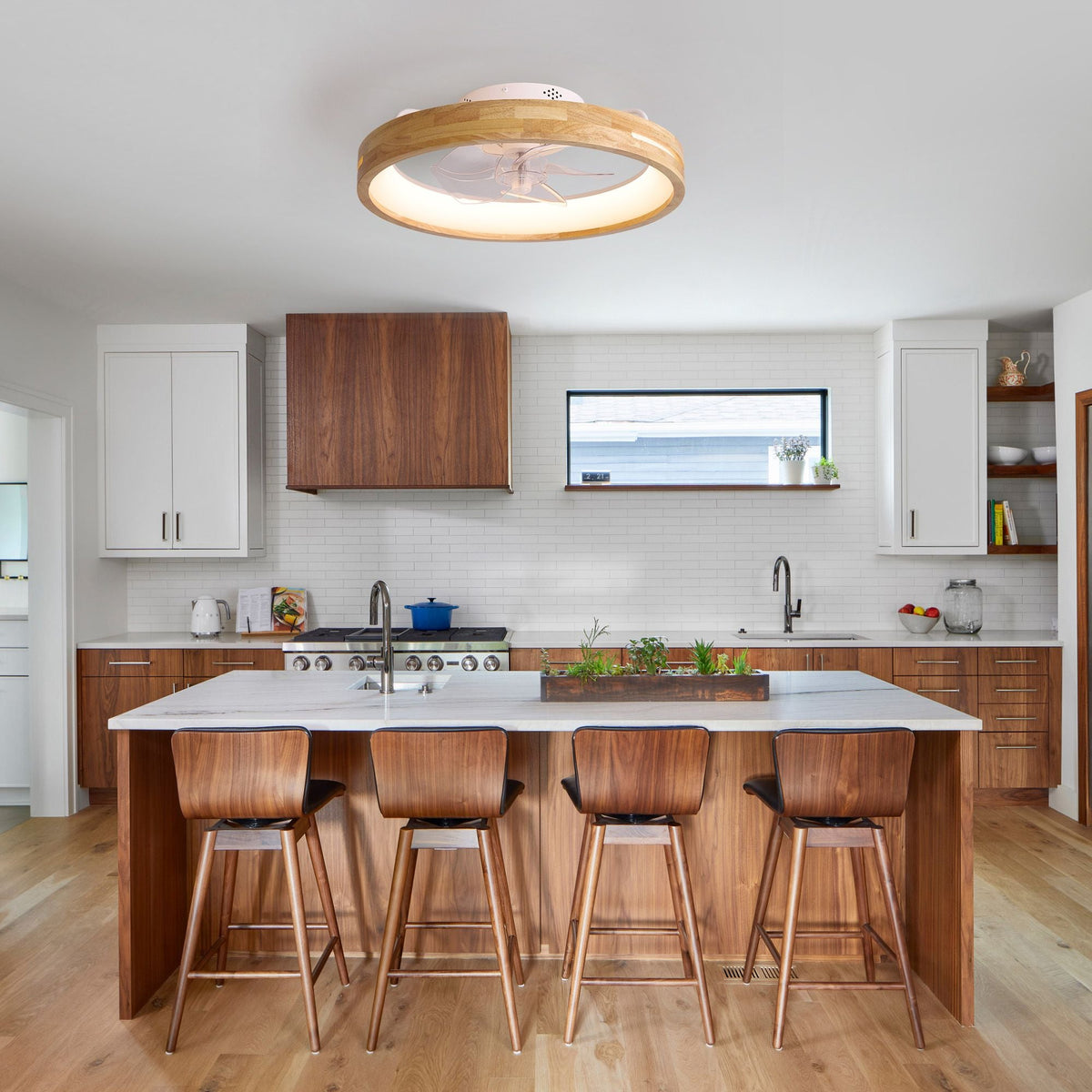Aeria Modern Ceiling Fan over kitchen island — wood and white cabinetry, stone countertop, wood stools, coastal vibe | CARRA HOME