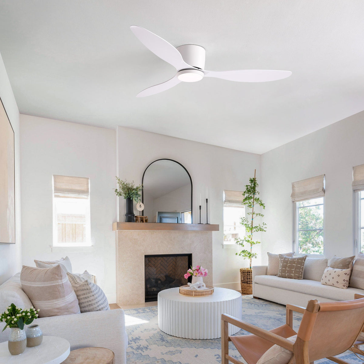 Aeroform White Ceiling Fan in bright modern living room — large windows, beige sofa, natural light, stylish air circulation without sacrificing aesthetics | CARRA HOME