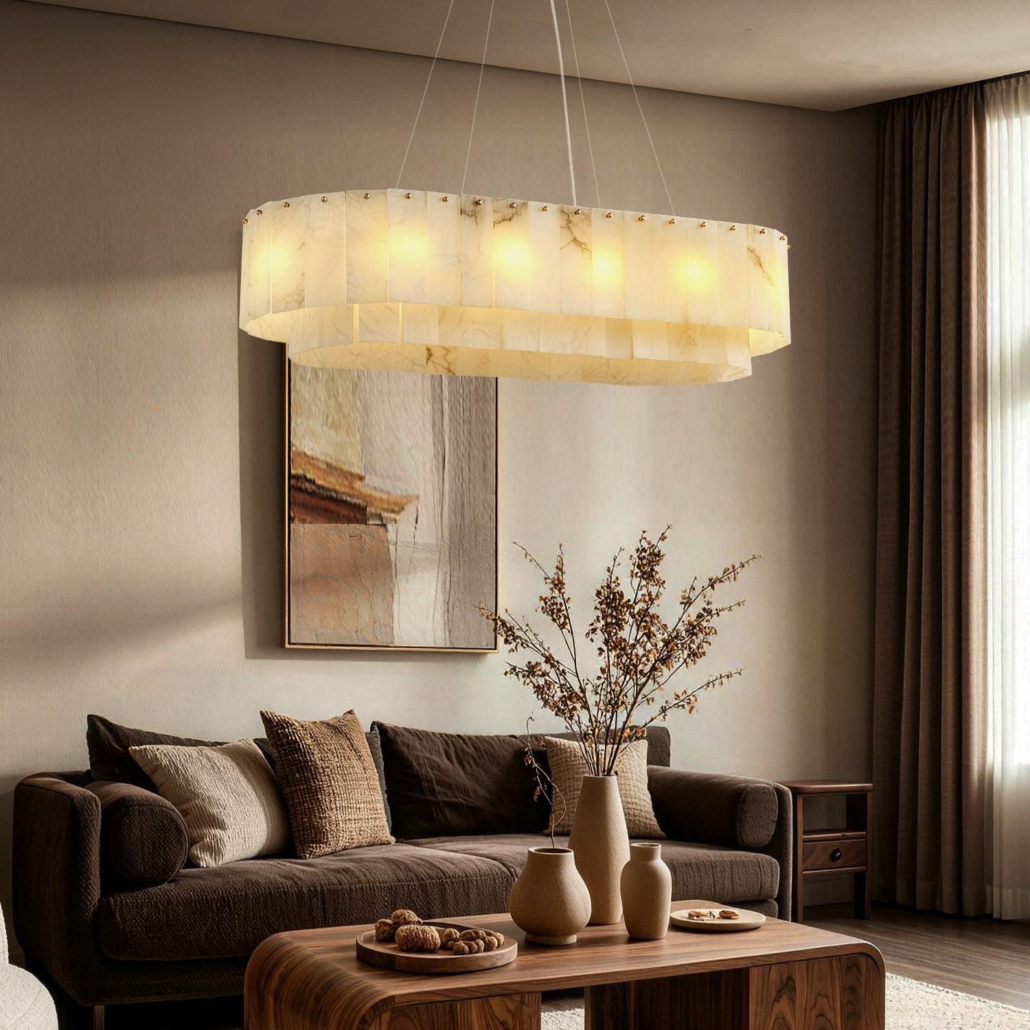 Aethel Modern Natural Alabaster Linear Chandelier in a living room — suspended above a round wooden coffee table with a dark sofa, abstract wall art, and elegant sculptures, creating a warm ambient glow -carra-home