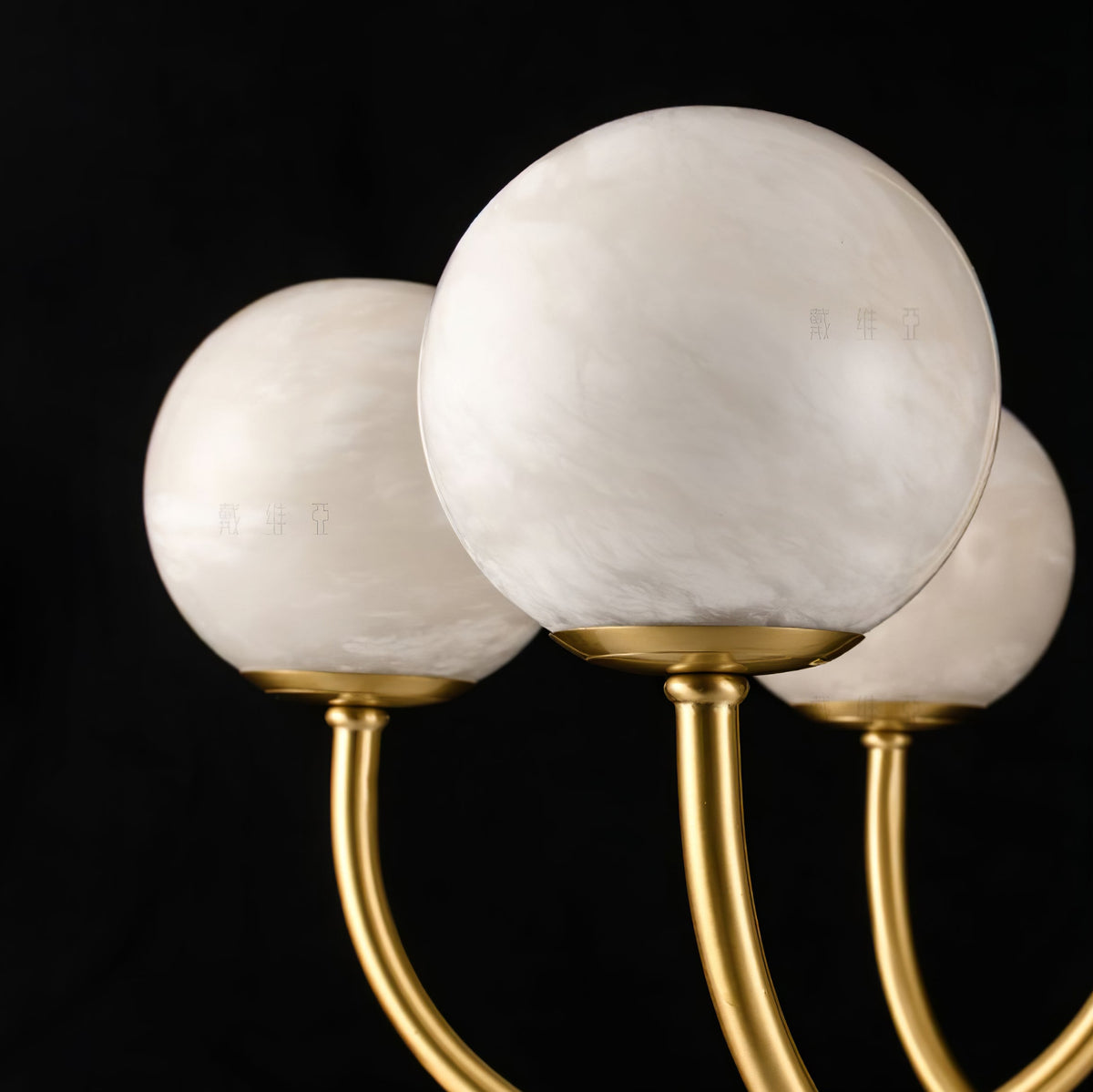 White alabaster globes on curved gold arms | CARRA HOME