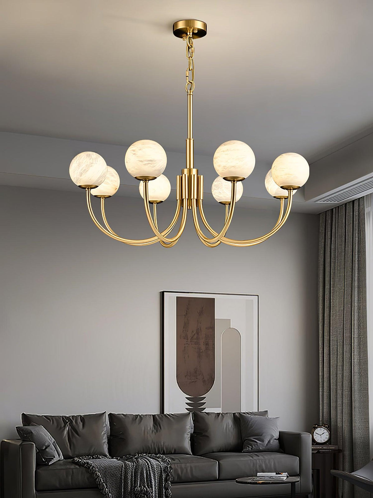 Gold alabaster globe chandelier above a living room seating area | CARRA HOME