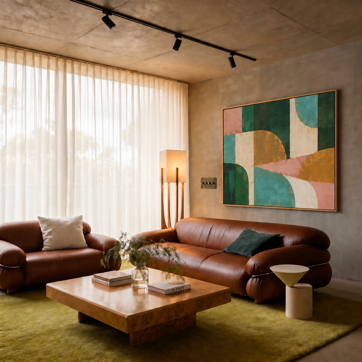 Four-gang bronze rotary dimmer switch with seamless faceplate in a leather-sofa living room with abstract artwork | CARRA HOME