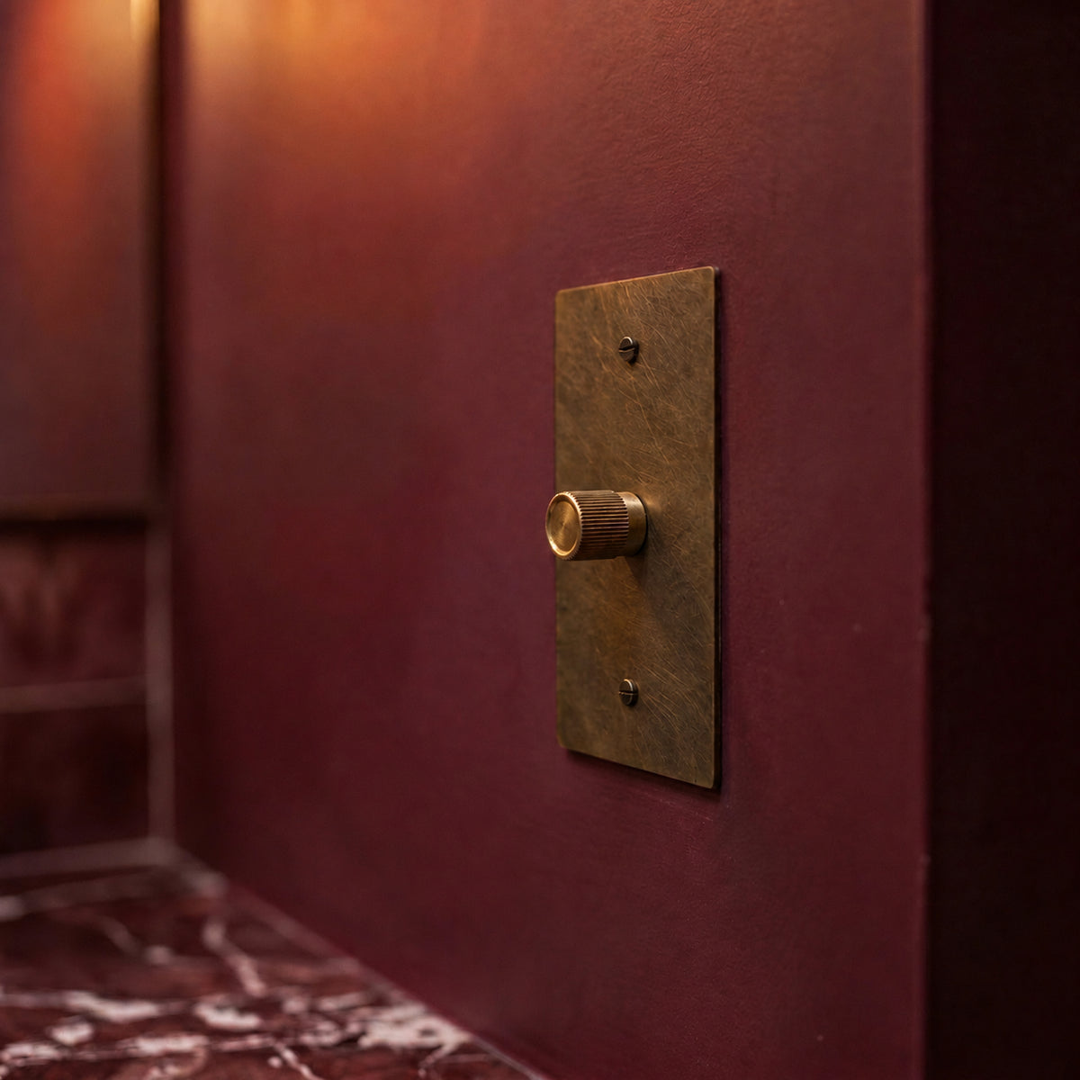 Brass Rotary Dimmer Switch installed in an interior, view 43 — seamless faceplate | CARRA HOME