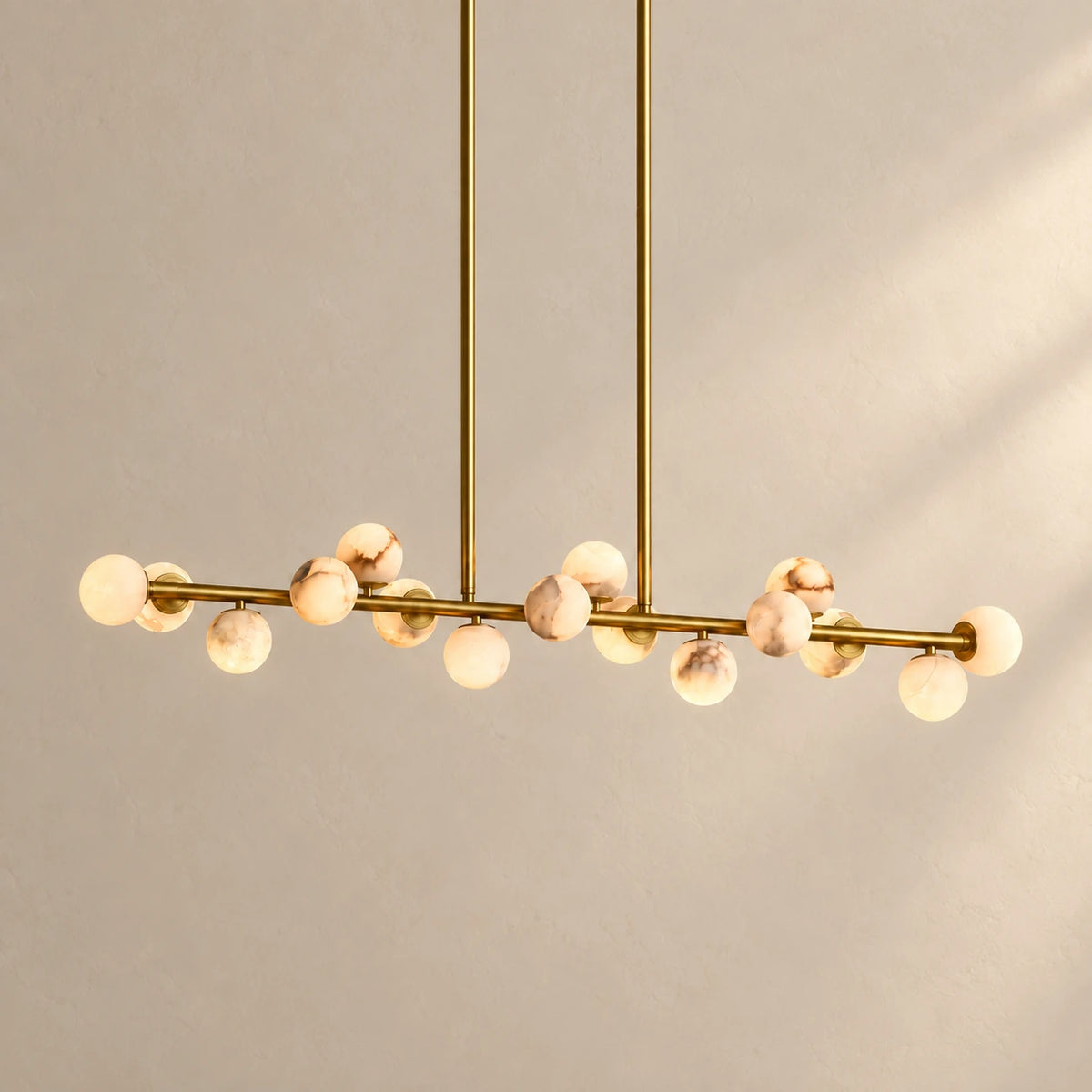 Orbelia alabaster globe linear chandelier silhouette.