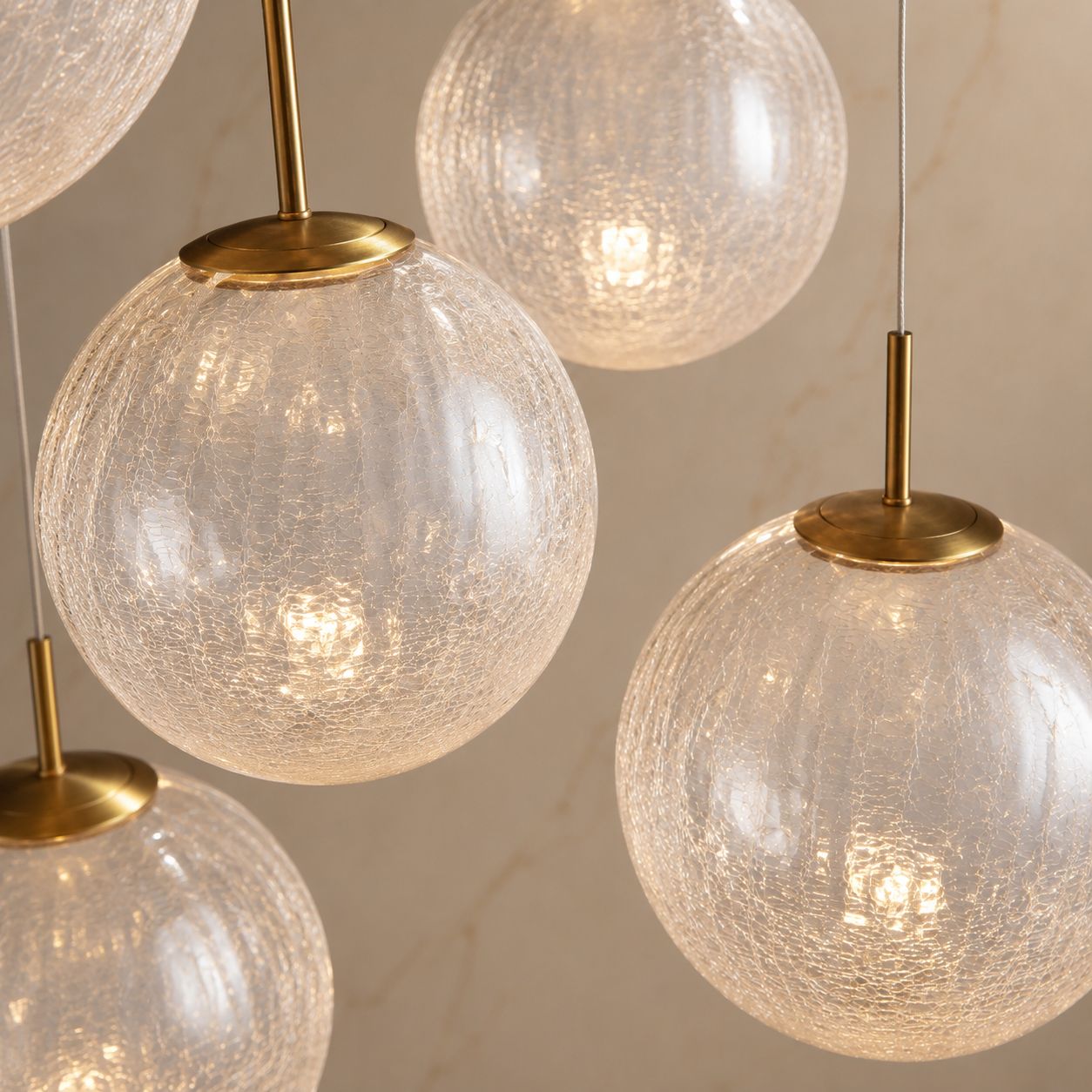 Close-up of Casen’s hand-blown textured glass globes — subtle crackle pattern, soft diffused light, and premium brass connectors for refined craftsmanship | Carra Home