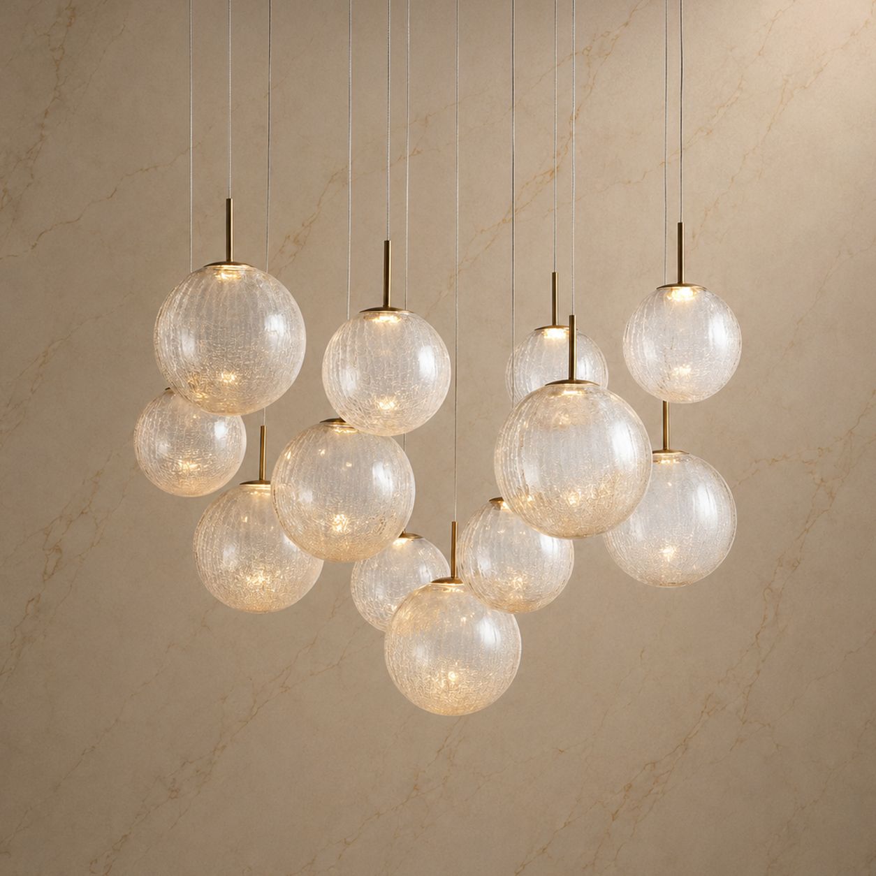 Casen Sculptural Chandelier illuminated — warm ambient glow through textured glass globes, brass fixtures, and cascading design for luxurious modern interiors | Carra Home