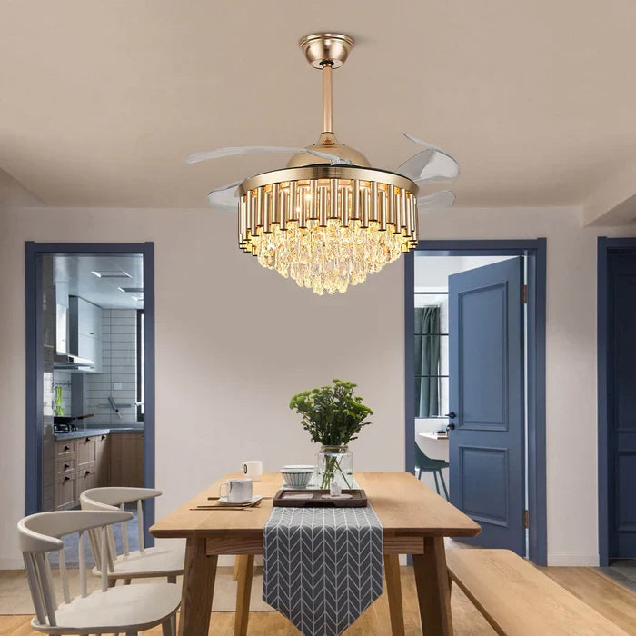 Crownelle Luxury K9 Crystal Retractable Ceiling Fan Chandelier in a dining room — suspended above a wooden dining table, combining functionality and luxury with its crystal accents