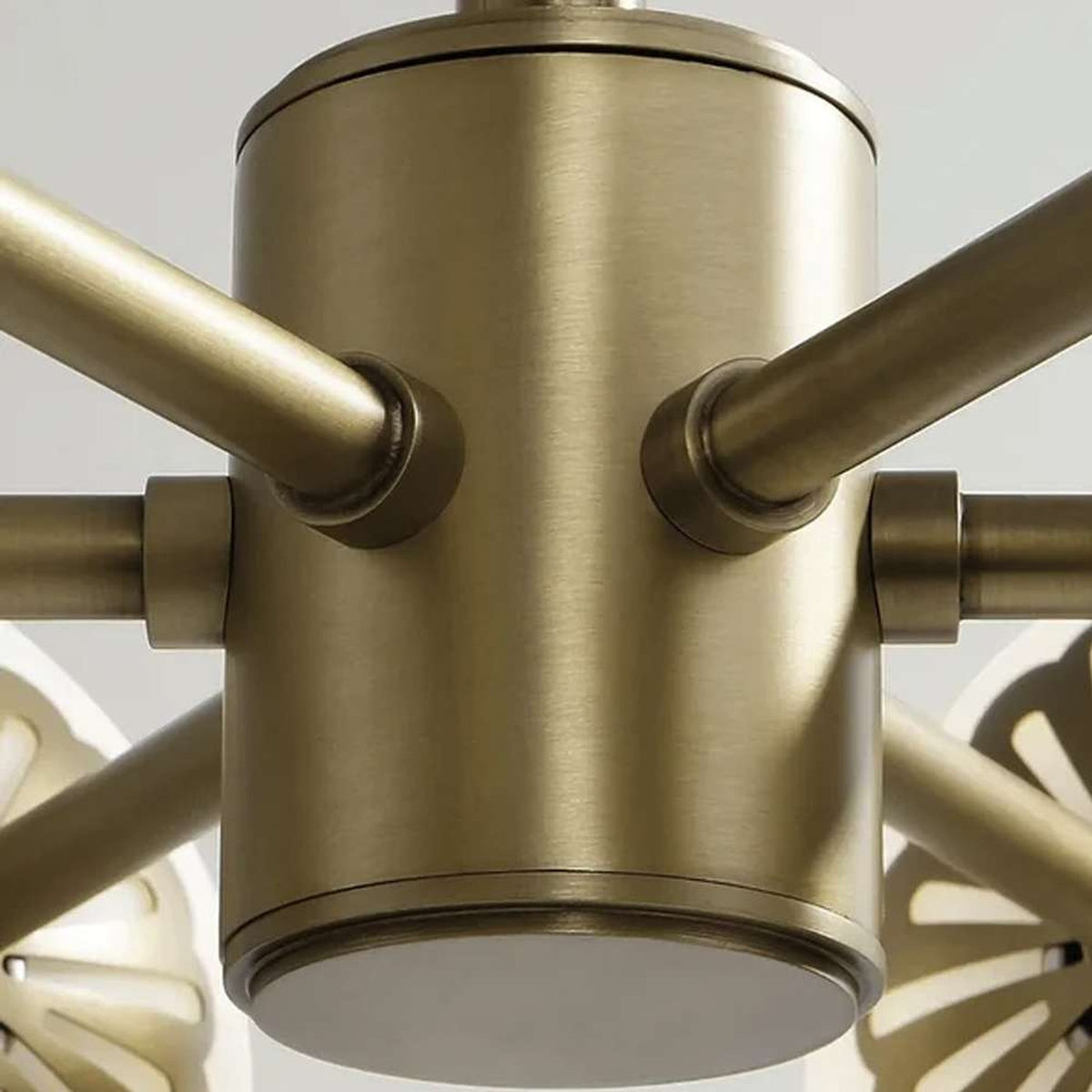 Close-up of the Dewdrop chandelier's brushed brass hub and radial arm connections | CARRA HOME