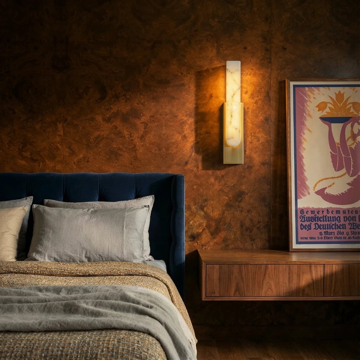 Emilia gold wall sconce beside a bed | CARRA HOME