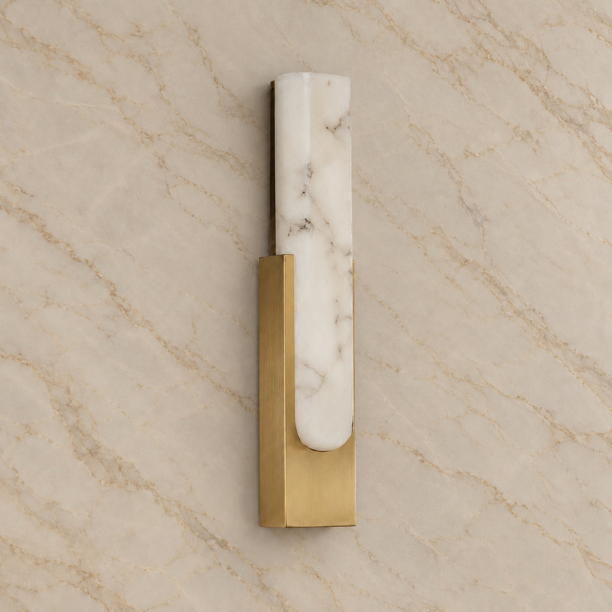 Emilia Alabaster Wall Sconce with gold hardware, switched off, on a marble wall | CARRA HOME