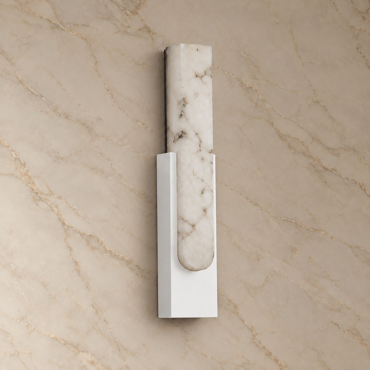 Emilia Alabaster Wall Sconce with white hardware, switched off, on a marble wall | CARRA HOME