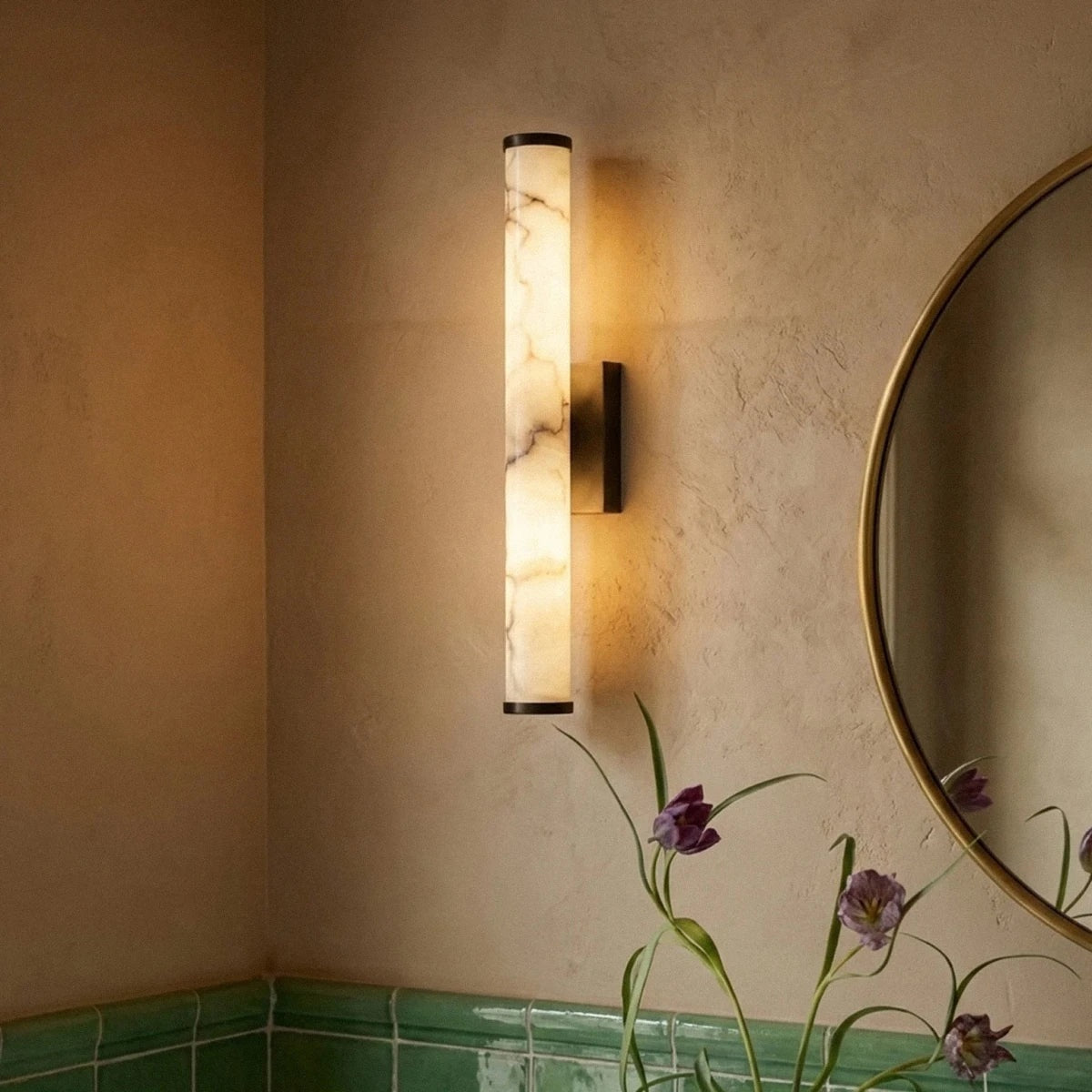 Falynis wall sconce beside a mirror | CARRA HOME