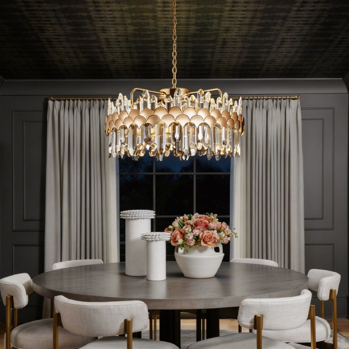 round gold crystal chandelier creating warm ambient lighting in modern dining room at night | Carra Home