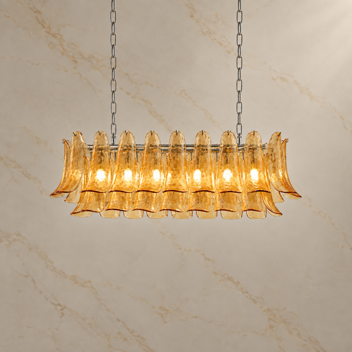 Liora amber glass petal linear chandelier, illuminated | CARRA HOME