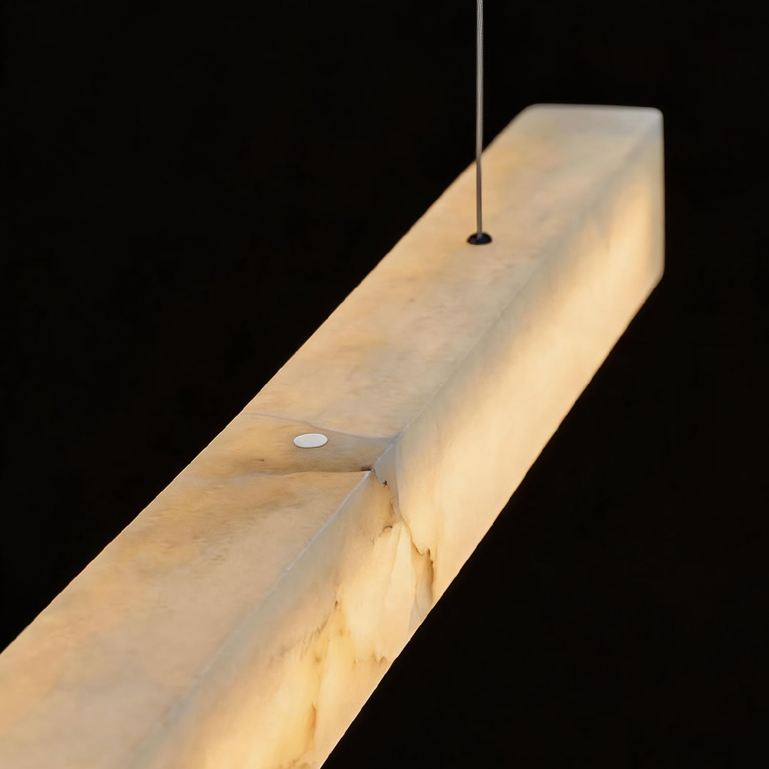 Close-up detail of the Horizon Modern Minimalist Alabaster Ultra-Slim Linear LED Chandelier — showcasing the natural alabaster stone texture with warm, translucent glow and sleek metal frame -carra-home